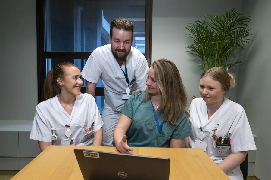 En gruppe helsepersonell som ser på en datamaskin